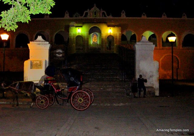 Izamal - in the night - looking to the gates of the monastery - a horse coach in front